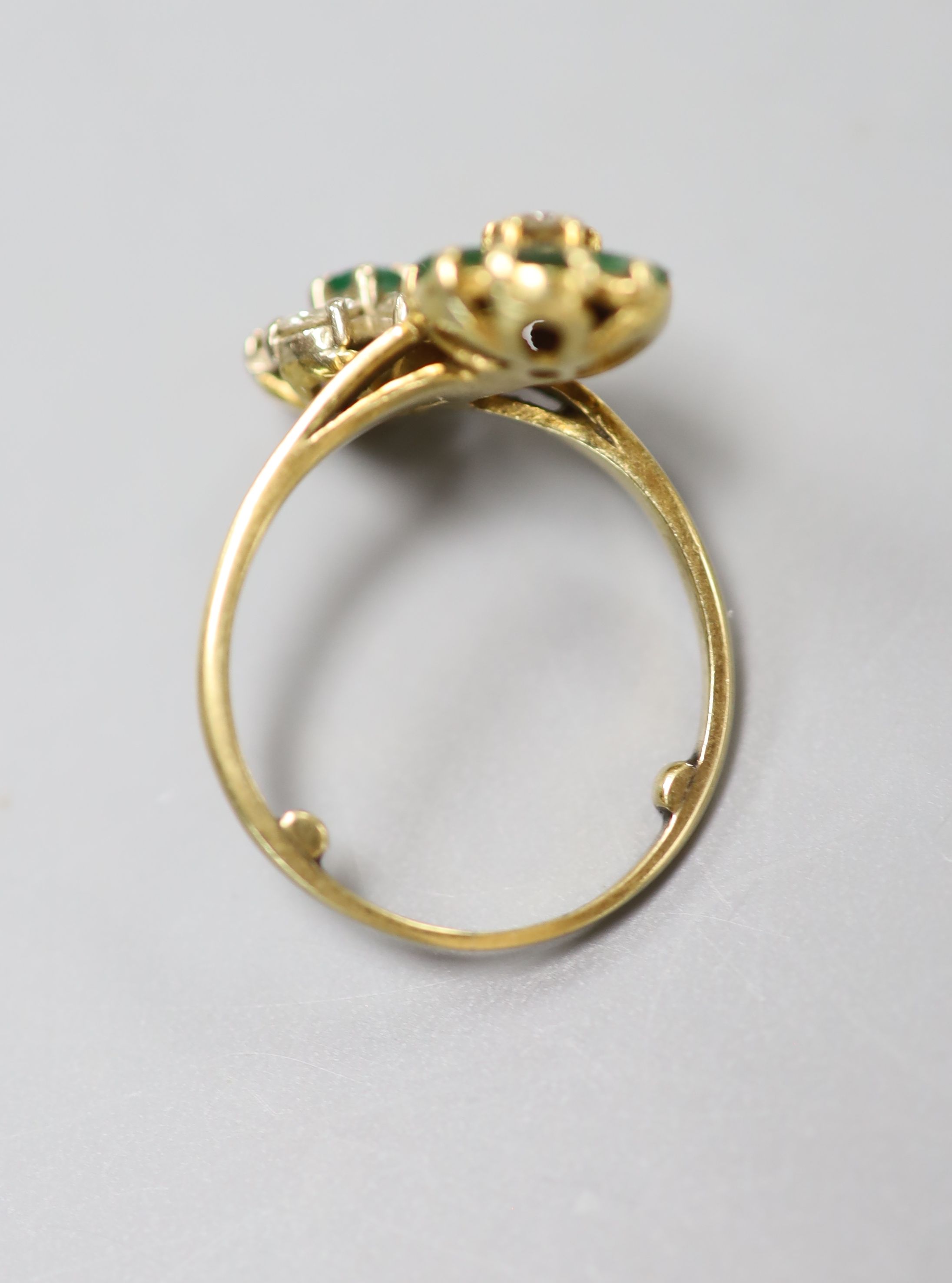 An 18ct, emerald and diamond double flowerhead cluster ring, size M, gross 4.5 grams.
